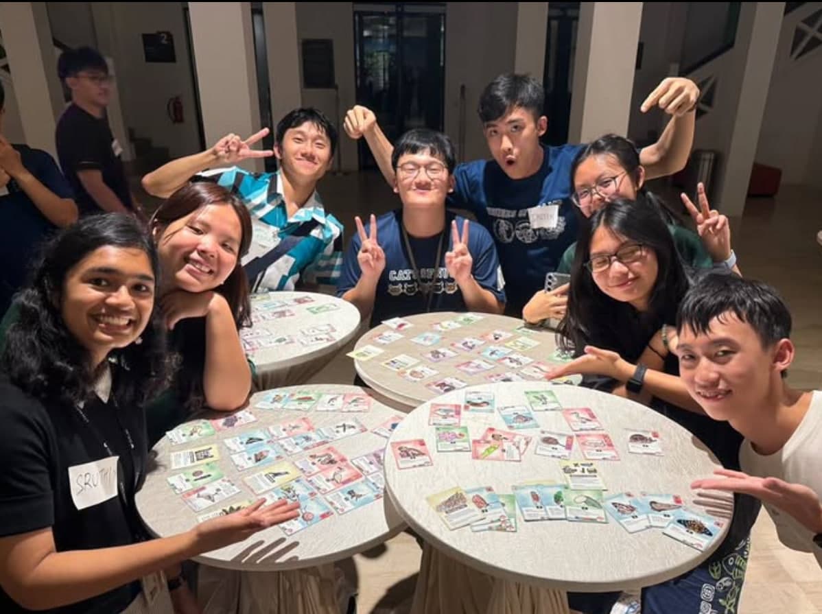 Participants playing the ByeO Barelands biodiversity card game together at a workshop